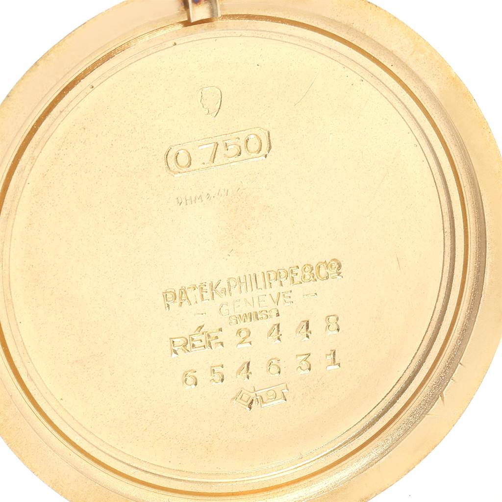 This image shows the inner case back of a Vintage Patek Philippe watch, featuring various engravings and reference numbers.