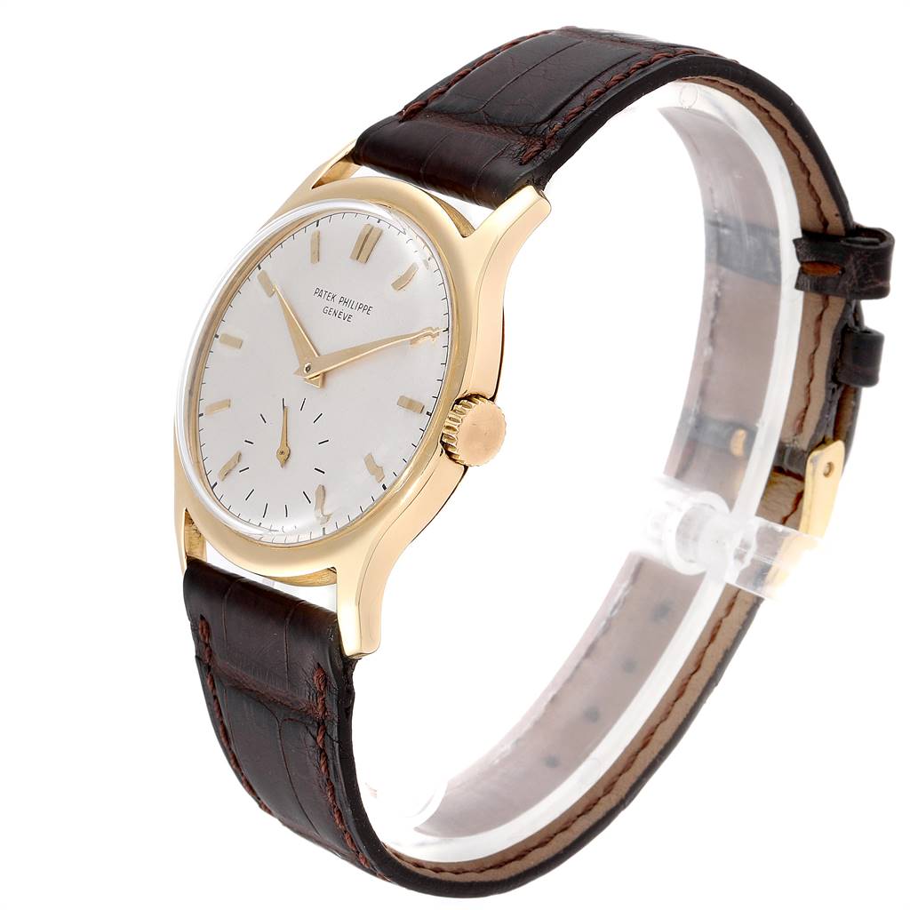 This image shows a side angle of a Vintage Patek Philippe watch featuring the dial, crown, and leather strap.