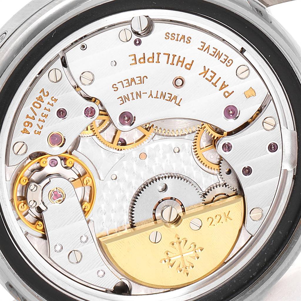 The image shows the back view of the Patek Philippe 5055G Men's White Gold Black Dial 5055G Men's White Gold Black Dial Moonphase Power Reserve White Gold Automatic Watch 5055, displaying its inner mechanics.