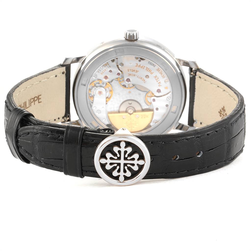 The image shows the back view of the Patek Philippe 5055G Men's White Gold Black Dial 5055G Men's White Gold Black Dial Moonphase Power Reserve White Gold Automatic Watch 5055, highlighting the movement and black strap.