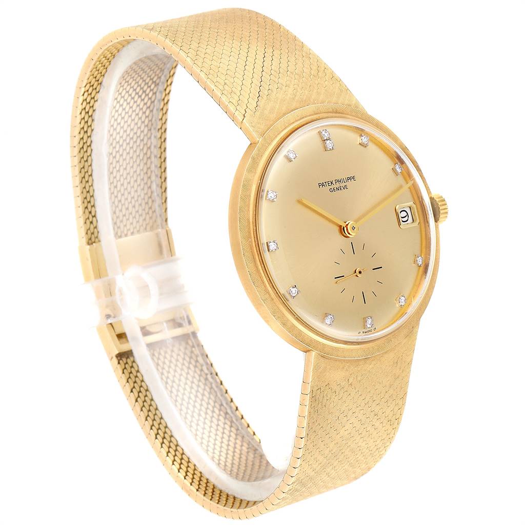 The image shows a Patek Philippe Vintage watch at a side angle, displaying the gold dial, hour markers, and gold mesh band.