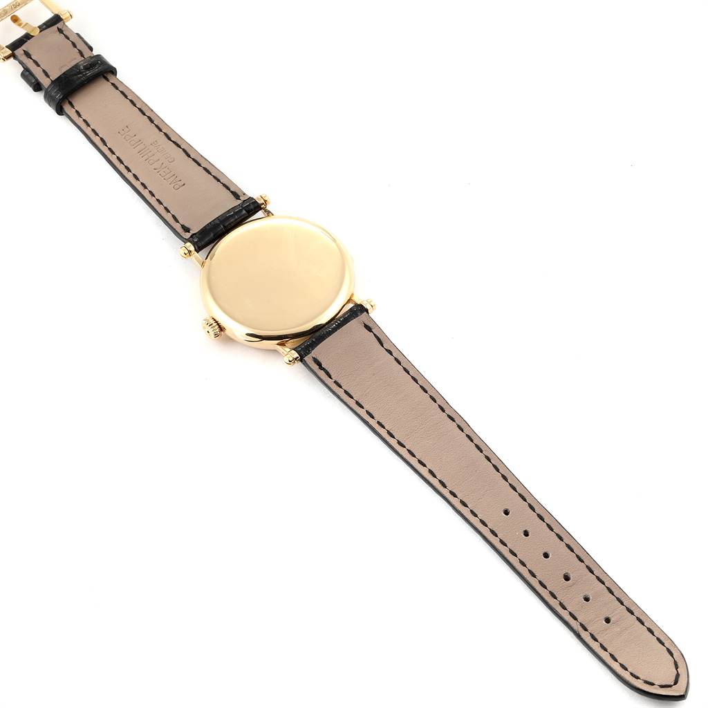 The image shows the back view of a Patek Philippe Calatrava 3960 Men's Yellow Gold White Dial 3960 Men's Yellow Gold White Dial watch, highlighting its case, strap, and buckle.