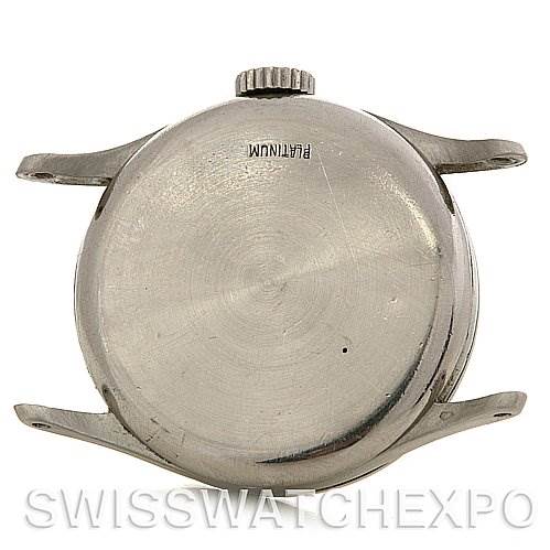 This image shows the back case and crown of a vintage Patek Philippe watch at a top-down angle.