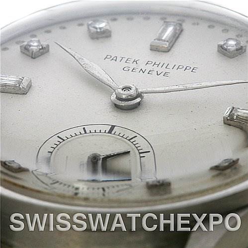 The image shows a close-up of the dial and hands of a Vintage Patek Philippe watch, highlighting the brand name and indices.