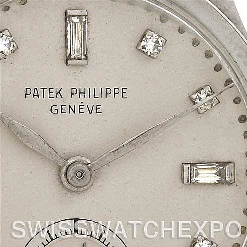 This image shows a close-up of the dial and hands of a Vintage Patek Philippe watch, with its brand name and markers visible.