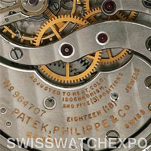 This image shows the intricate inner workings, including gears, of a vintage Patek Philippe watch model number 964707.