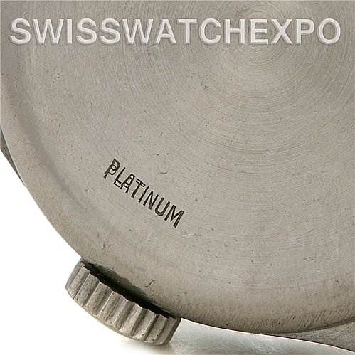 This image shows a close-up of the side of a Vintage Patek Philippe watch case, highlighting the "Platinum" engraving and the crown.