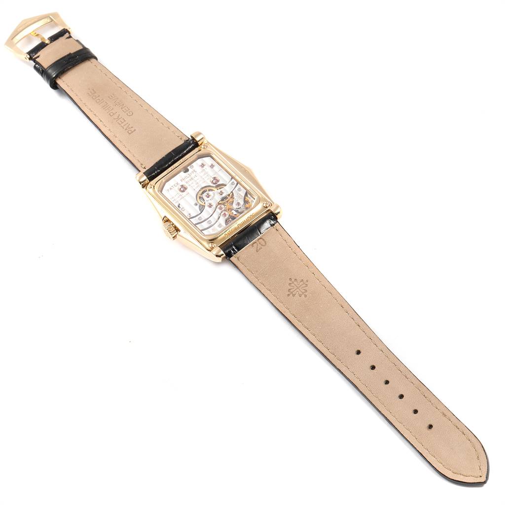 The image shows the rear view of the Patek Philippe Gondolo 5100J Men's Yellow Gold Silver Dial 5100J Men's Yellow Gold Silver Dial watch, displaying its intricate back mechanisms and leather strap.