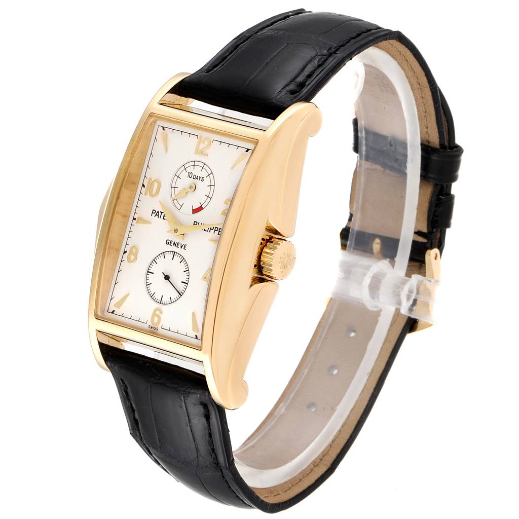 The Patek Philippe Gondolo 5100J Men's Yellow Gold Silver Dial 5100J Men's Yellow Gold Silver Dial watch is shown at a three-quarter angle, highlighting the dial, case, crown, and leather strap.