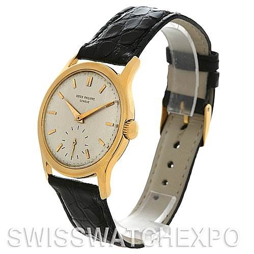 The image shows a side angle of a Vintage Patek Philippe watch, highlighting its face, crown, and black leather strap.