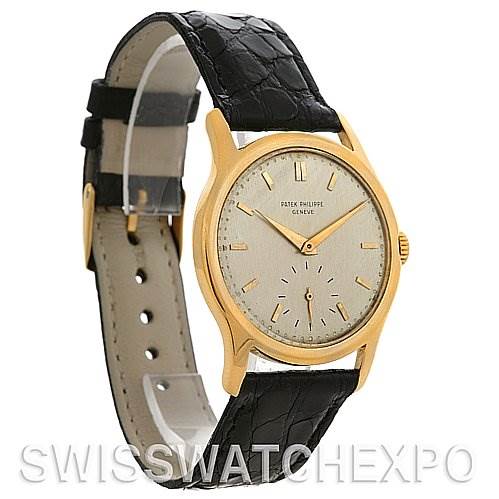 The image shows a side-view angle of the Vintage Patek Philippe watch, highlighting its face, hands, and black leather strap.