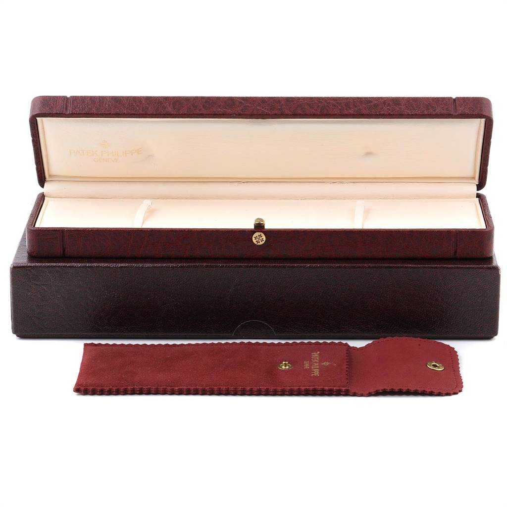 This image shows the opened burgundy and cream box and a soft case for the Patek Philippe Golden Ellipse 5738R Men's Rose Gold Black Dial 5738R Men's Rose Gold Black Dial watch from the front.