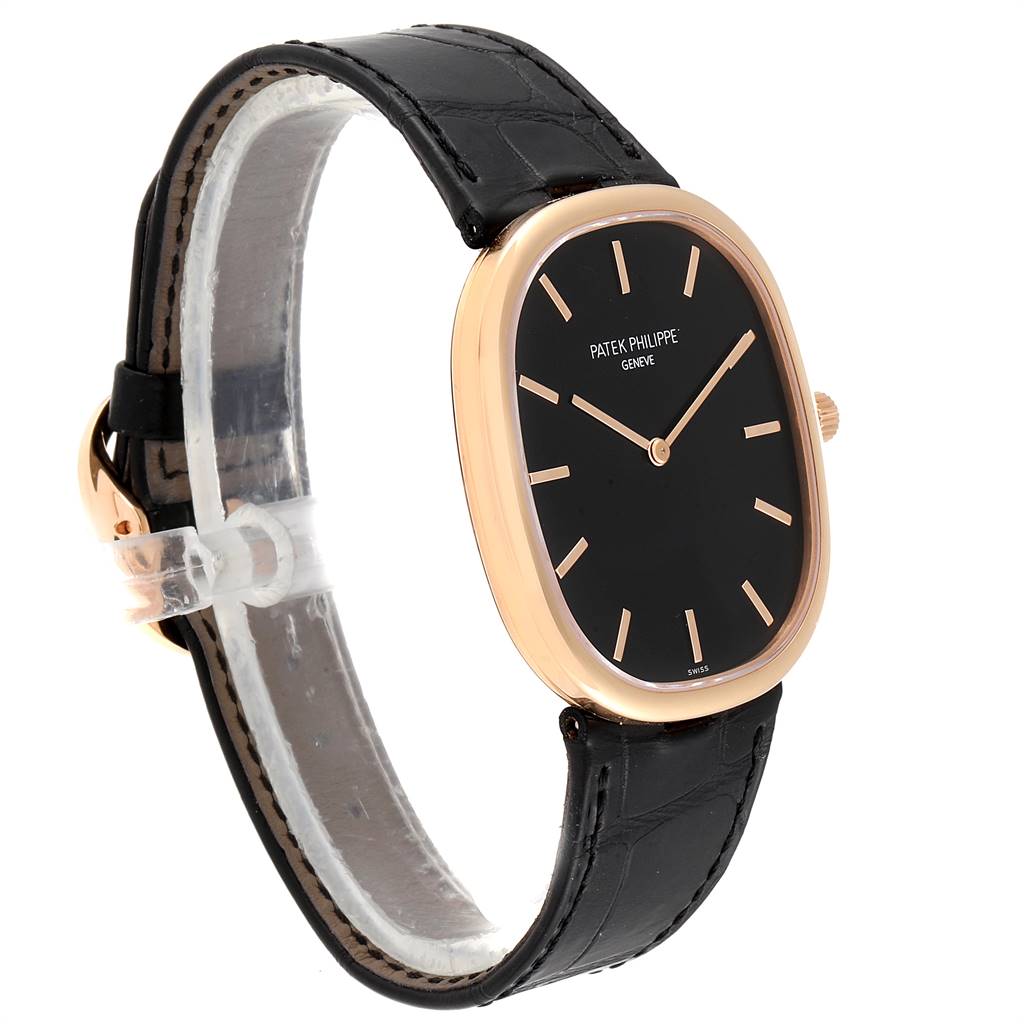 The image shows a side angle of a Patek Philippe Golden Ellipse 5738R Men's Rose Gold Black Dial 5738R Men's Rose Gold Black Dial watch, highlighting its black leather strap and gold oval case.