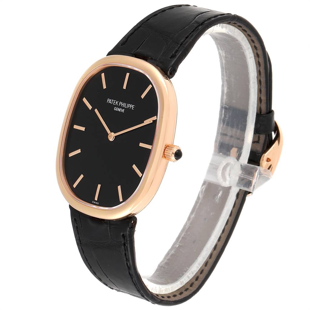 The image shows a Patek Philippe Golden Ellipse 5738R Men's Rose Gold Black Dial 5738R Men's Rose Gold Black Dial watch from a 3/4 angle, highlighting the black dial, rose gold case, and black leather strap.