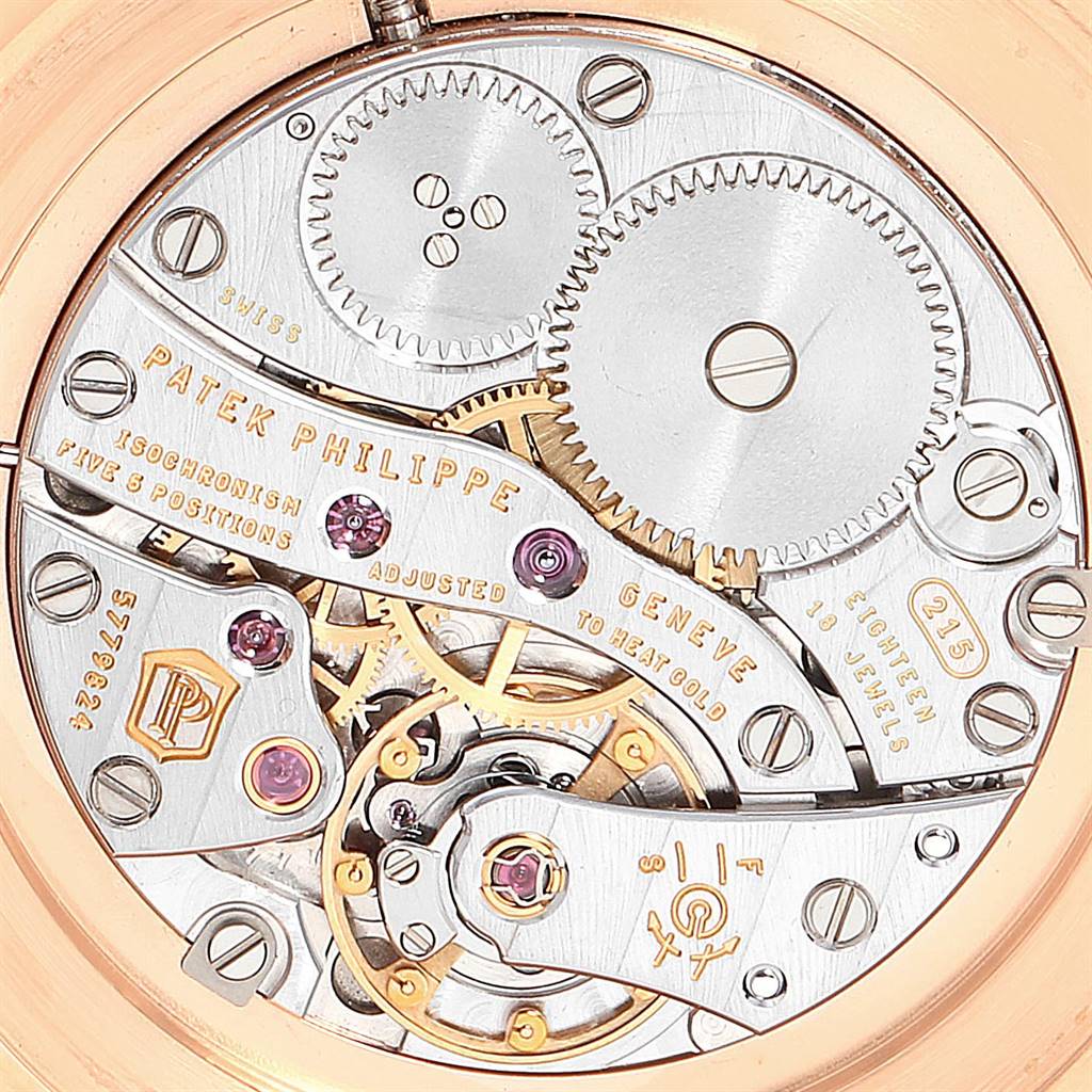 The image shows the movement and inner mechanics of a Patek Philippe Calatrava 5119R Men's Rose Gold White Dial 5119R Men's Rose Gold White Dial watch from a top-down angle.