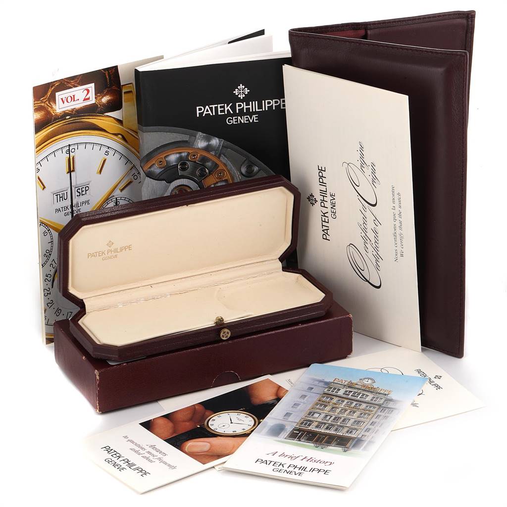 This image features the packaging and documentation for a Patek Philippe Gondolo 5024J Men's Yellow Gold White Dial 5024J Men's Yellow Gold White Dial watch, including a box, manuals, and certificates.
