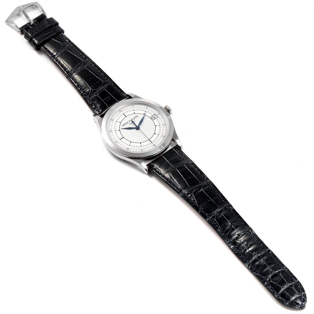 The image shows a top-down view of a Patek Philippe Calatrava 5296G Men
s White Gold Silver Dial 5296G Men
s White Gold Silver Dial watch, including the dial, case, and leather strap.