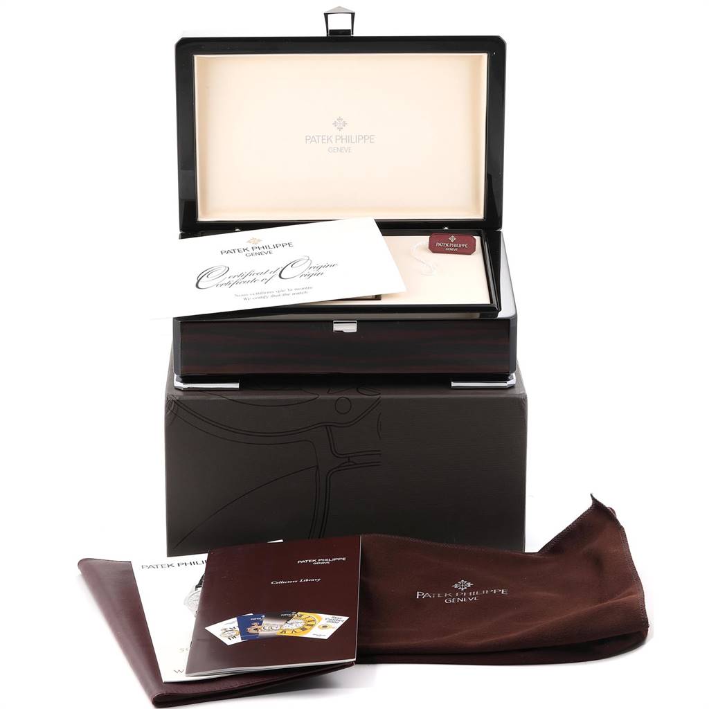 The image shows the packaging and accessories for a Patek Philippe Calatrava 5296G Men
s White Gold Silver Dial 5296G Men
s White Gold Silver Dial watch, including booklets and cloths, from a front angle.
