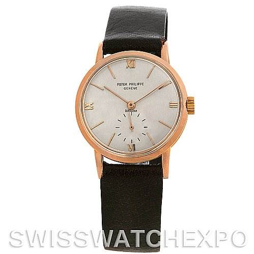 This image shows a front view of a Vintage Patek Philippe watch with a black strap, gold case, and minimalistic dial design.