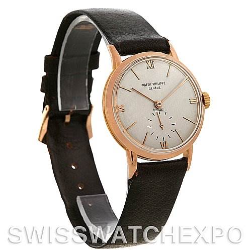 The image shows a side angle of a Vintage Patek Philippe watch, highlighting its dial, leather strap, and crown.