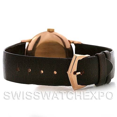 This image displays the back view of a Vintage Patek Philippe watch, showing the watch case, crown, and leather strap with a buckle.