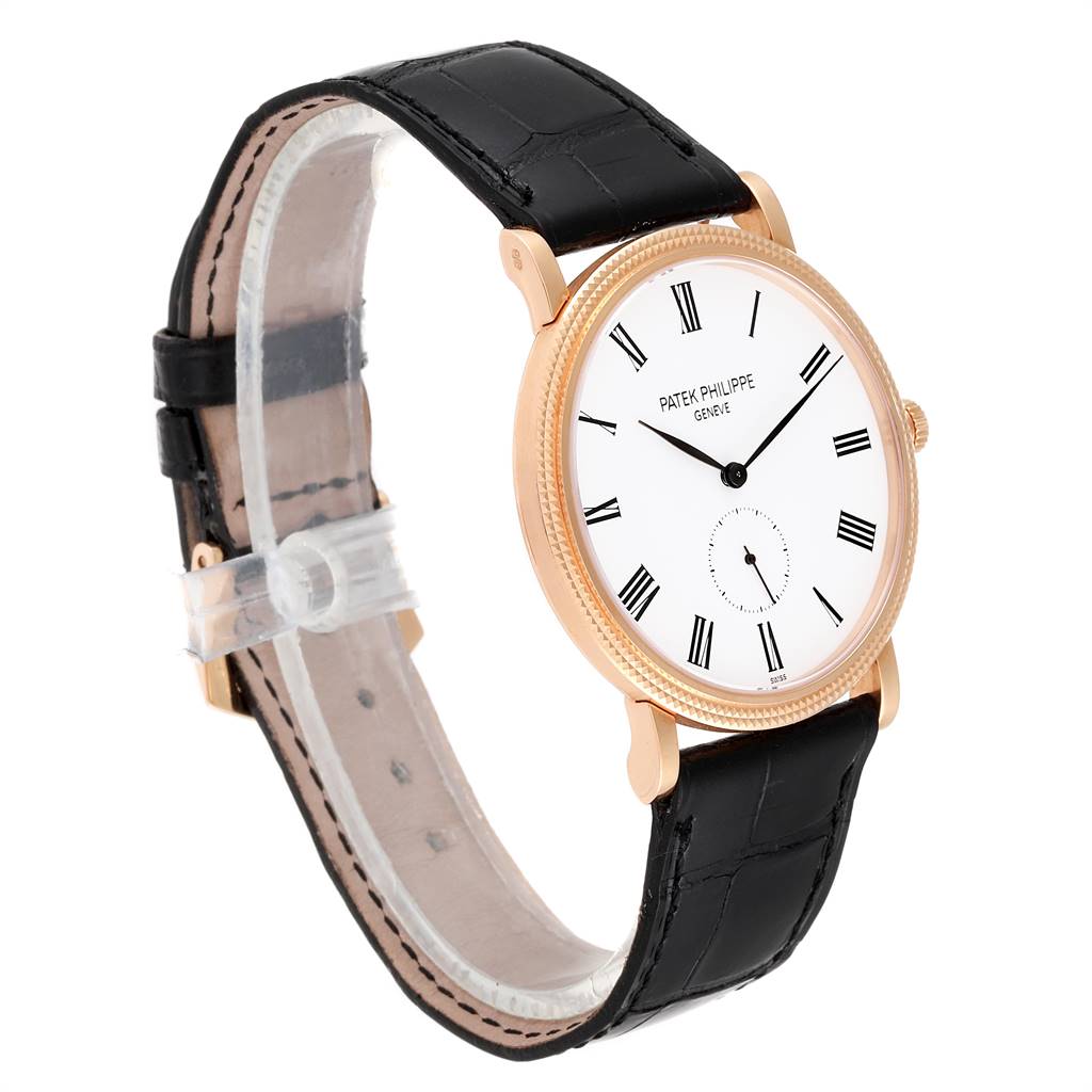 The Patek Philippe Calatrava 5119R Men's Rose Gold White Dial 5119R Men's Rose Gold White Dial watch is shown at an angle displaying the face, dial, case, and part of the leather strap.