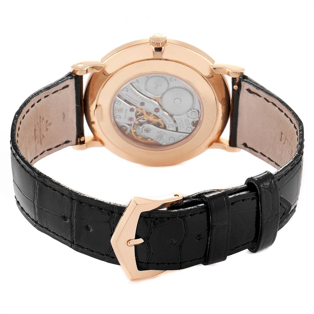 The image shows the back view of a Patek Philippe Calatrava 5119R Men's Rose Gold White Dial 5119R Men's Rose Gold White Dial watch, highlighting its transparent case back and black leather strap.