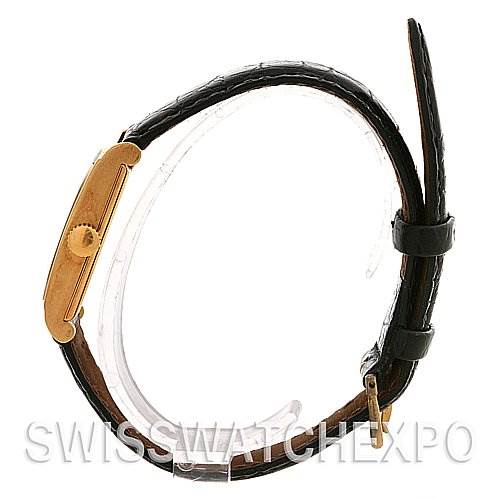 Side view of a Vintage Patek Philippe watch, showing the crown, case, and leather strap with a buckle.