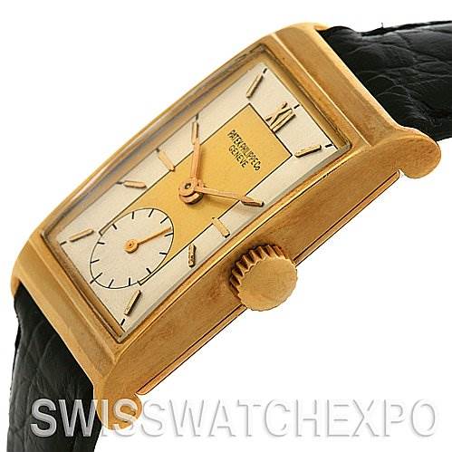 The image shows a side angle of a Vintage Patek Philippe watch, highlighting the dial, crown, and part of the black leather strap.