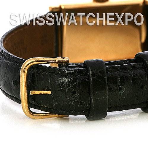 The image shows a side view of a Vintage Patek Philippe watch, focusing on the black leather strap and gold buckle.