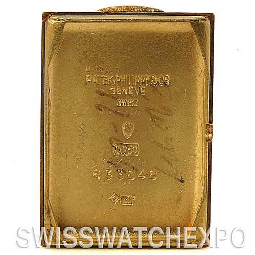 This image shows the back case of a Vintage Patek Philippe watch, displaying engravings and serial numbers.