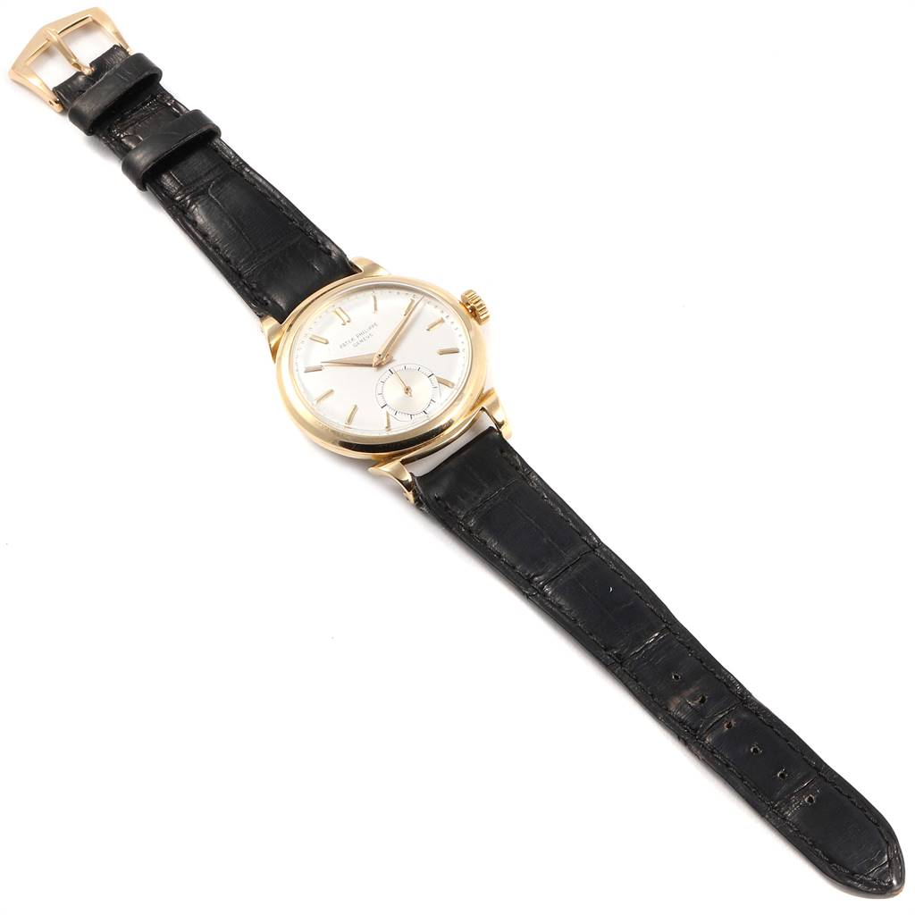 The image shows a Patek Philippe Vintage watch from a top view, showcasing its dial, case, crown, and leather strap.