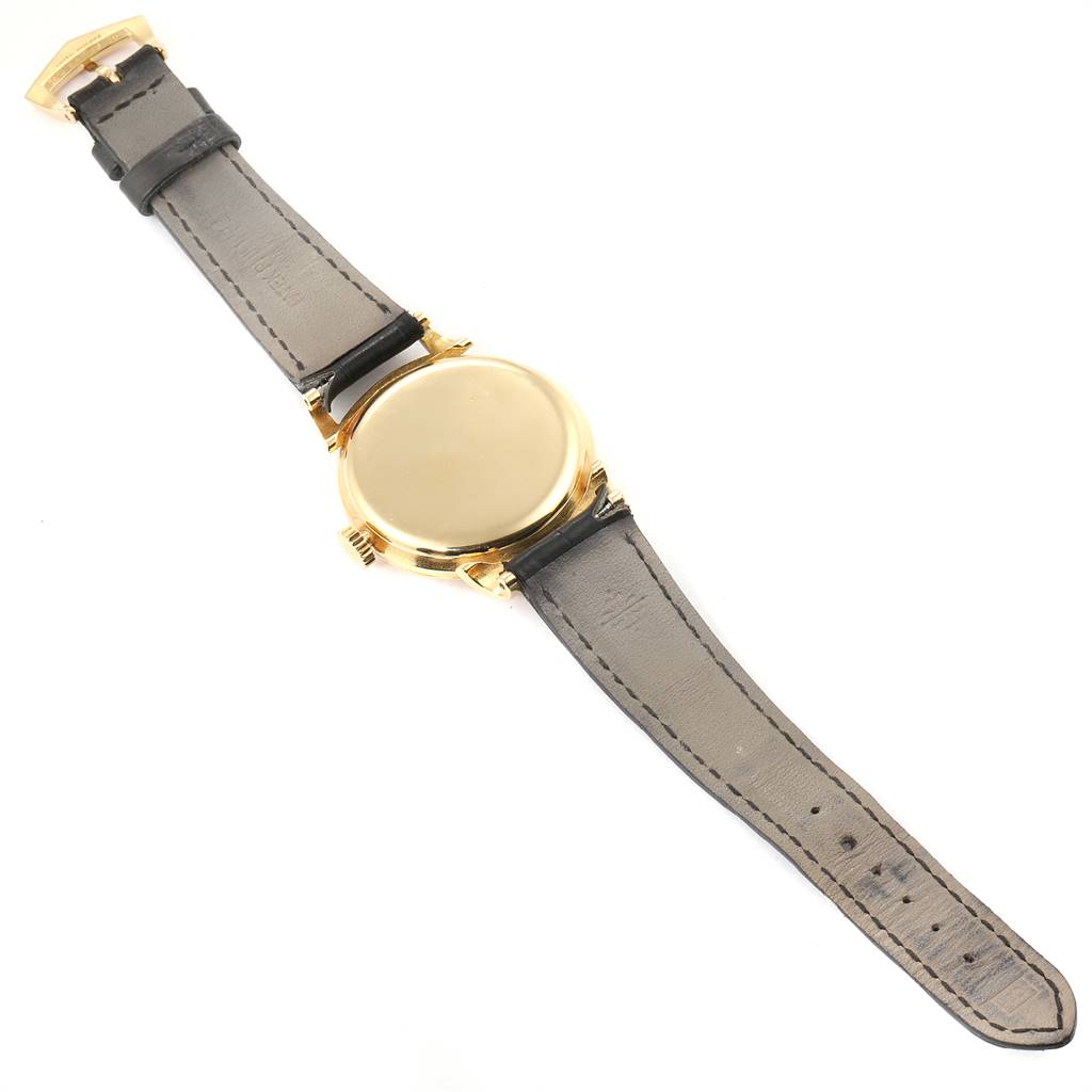 The image shows the back view of a Vintage Patek Philippe watch, including its leather strap and gold case.