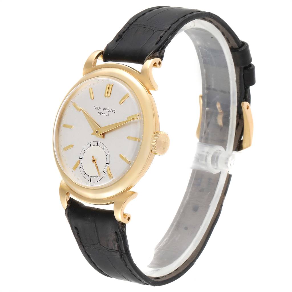 The image shows a Vintage Patek Philippe watch at a slight angle, including its face, bezel, crown, and black leather strap.