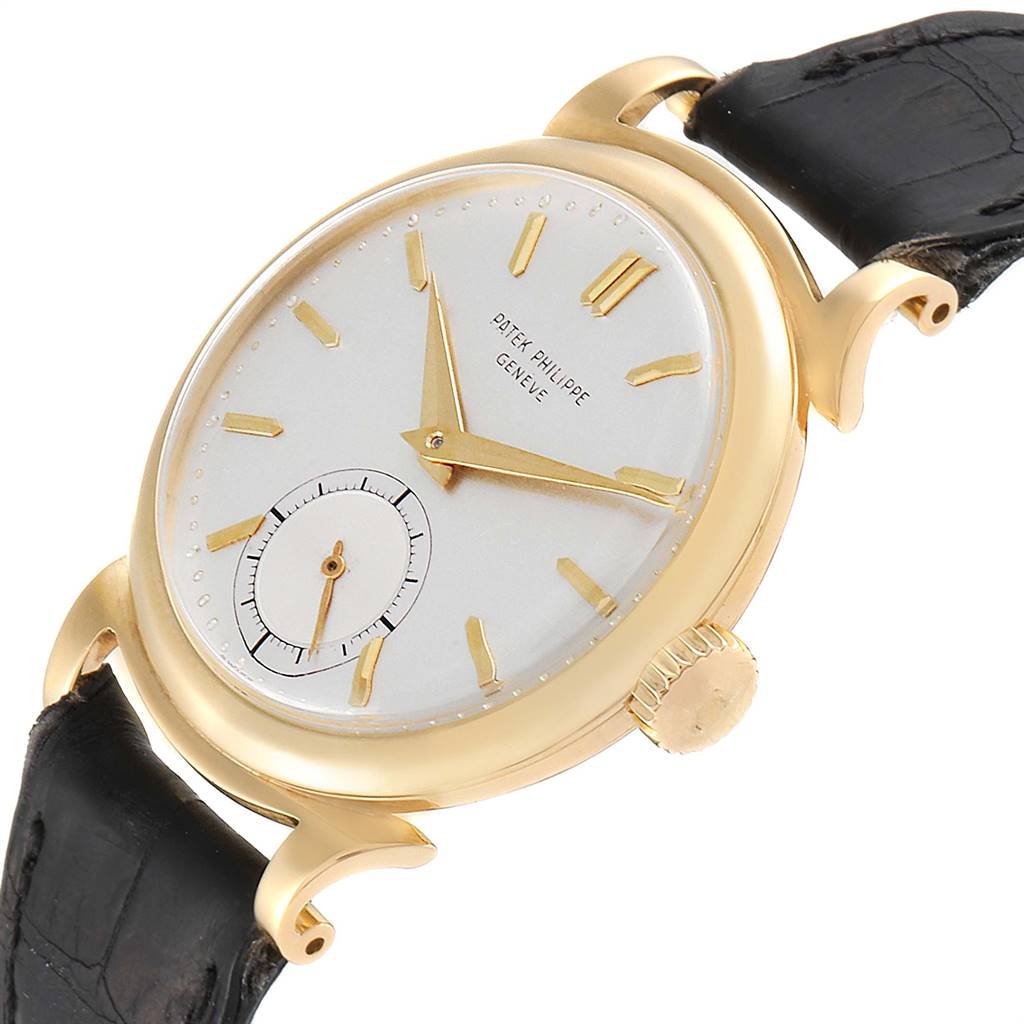 This image shows an angled side view of a Vintage Patek Philippe watch, highlighting the dial, case, crown, and leather strap.