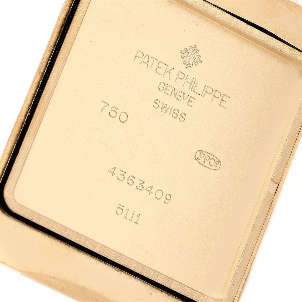 This image shows the back casing of the Patek Philippe Gondolo 51111J Men's Yellow Gold Silver Dial 51111J Men's Yellow Gold Silver Dial watch, displaying model numbers and brand inscriptions.