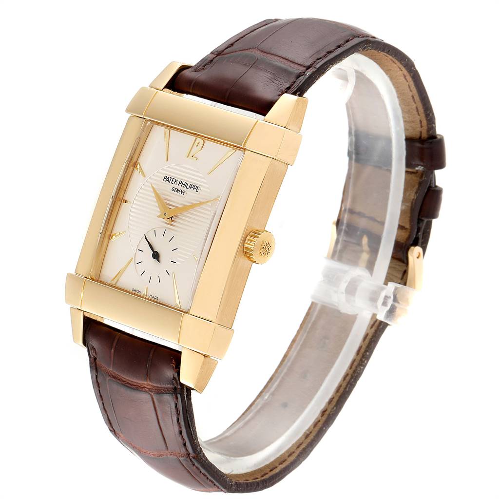 The Patek Philippe Gondolo 51111J Men's Yellow Gold Silver Dial 51111J Men's Yellow Gold Silver Dial watch is shown from a three-quarter angle, highlighting the rectangular gold case and brown leather strap.