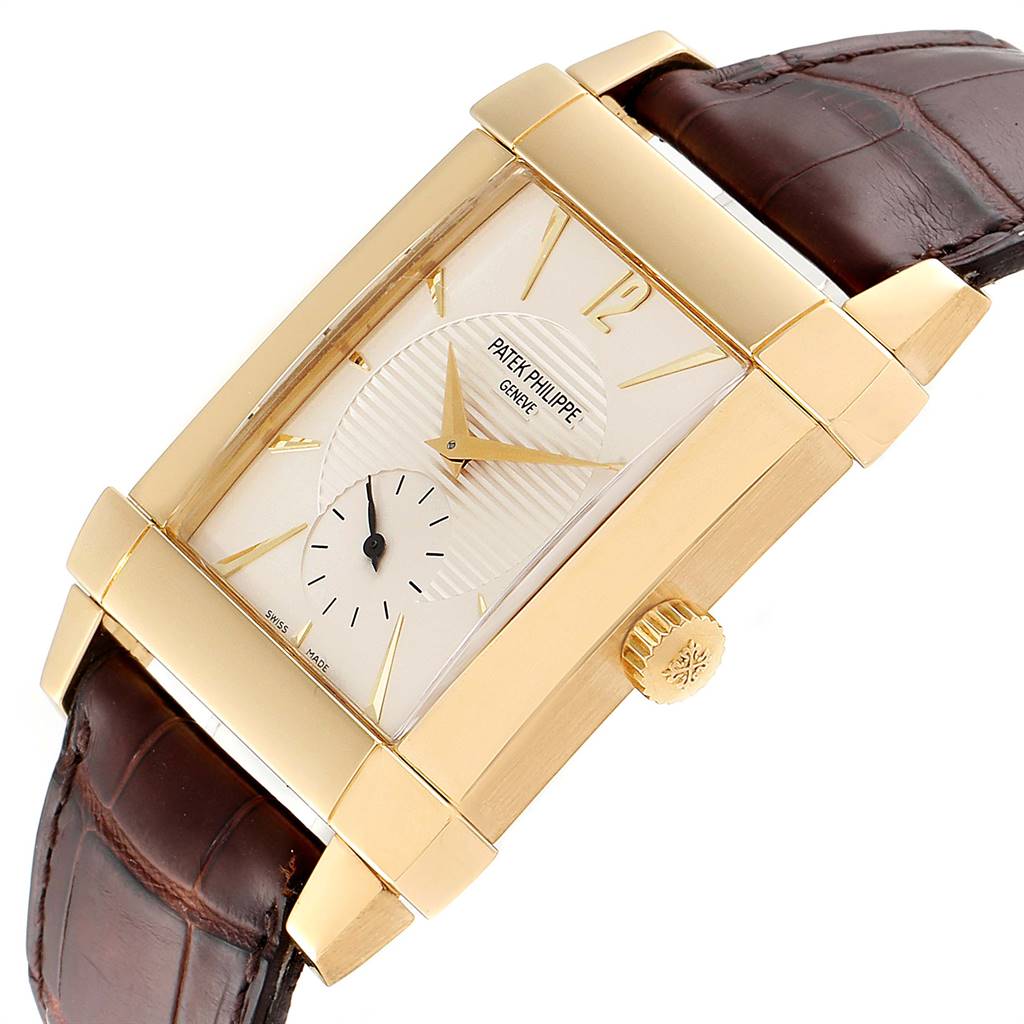 The image shows a side angle of the Patek Philippe Gondolo 51111J Men's Yellow Gold Silver Dial 51111J Men's Yellow Gold Silver Dial watch, clearly showing its rectangular dial, gold case, crown, and brown leather strap.
