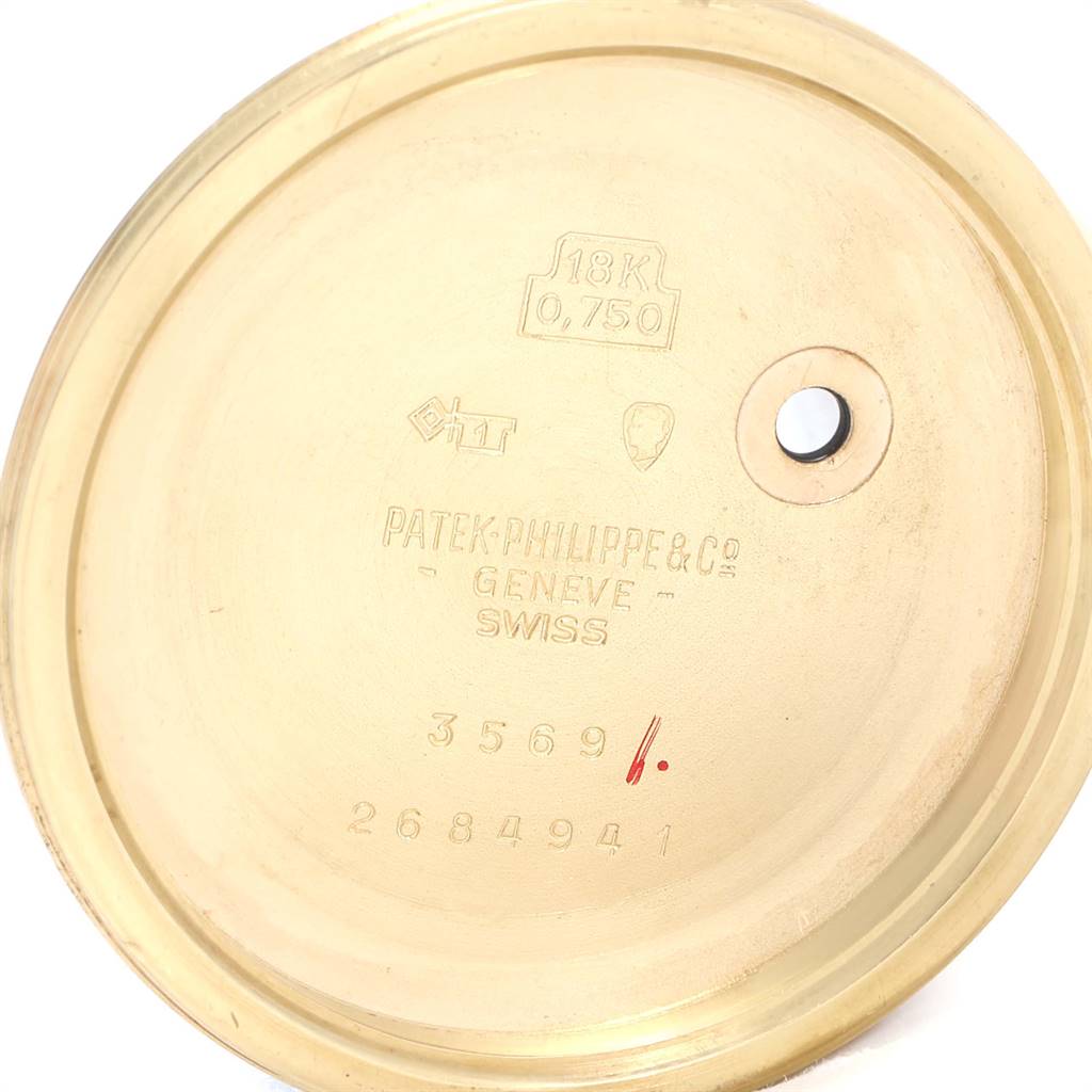 This image shows the inside of the case back of a Vintage Patek Philippe watch with engravings and hallmarks visible.