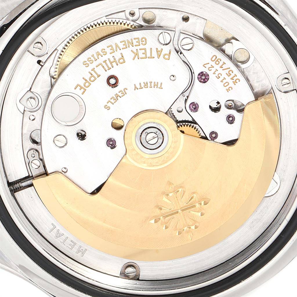 The image shows the detailed inner mechanism of the Patek Philippe Aquanaut 5065/1A-010 Men's Stainless Steel Black Dial 5065/1A-010 Men's Stainless Steel Black Dial watch, highlighting its intricate movements and branding.