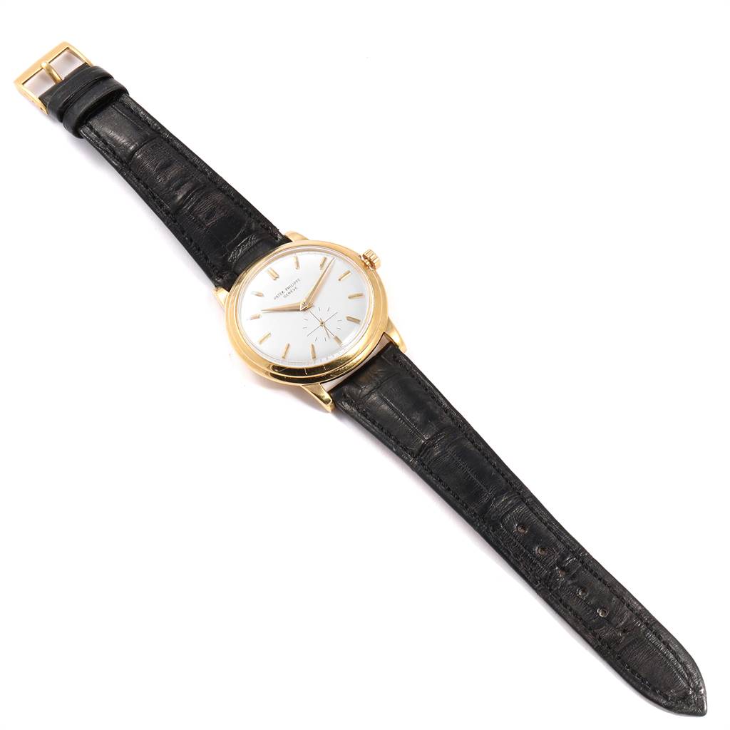 The image shows a top view of a Vintage Patek Philippe watch, displaying its dial, case, and black leather strap.