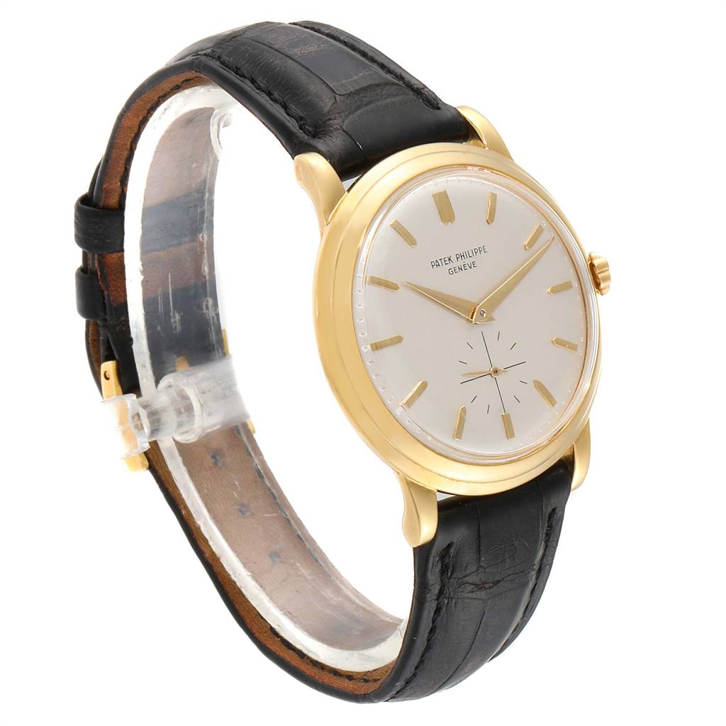 This image shows a Patek Philippe Vintage 2552 Men
s Yellow Gold Silver Dial 2552 Men
s Yellow Gold Silver Dial model watch from a side angle, featuring a gold case, white dial, and black leather strap.