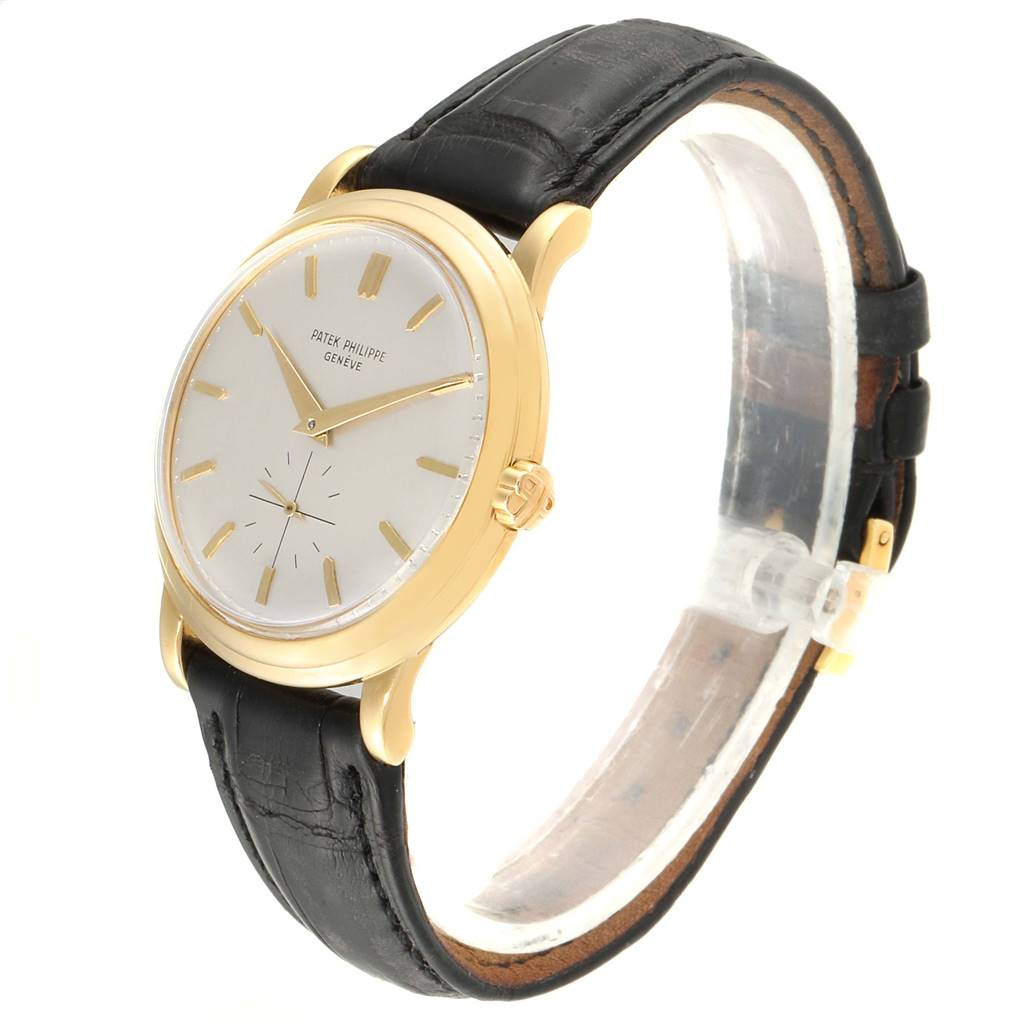 The image shows a side angle of the Vintage Patek Philippe watch, highlighting its gold case, white dial, and black leather strap.