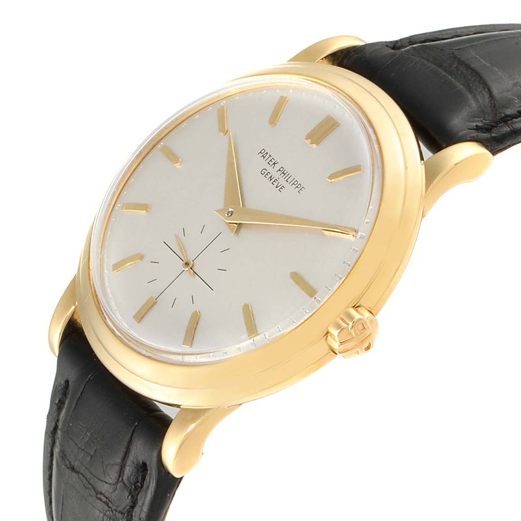 The image shows a side angle of a Patek Philippe Vintage 2552 Men
s Yellow Gold Silver Dial 2552 Men
s Yellow Gold Silver Dial watch, highlighting the dial, gold case, crown, and black leather strap.