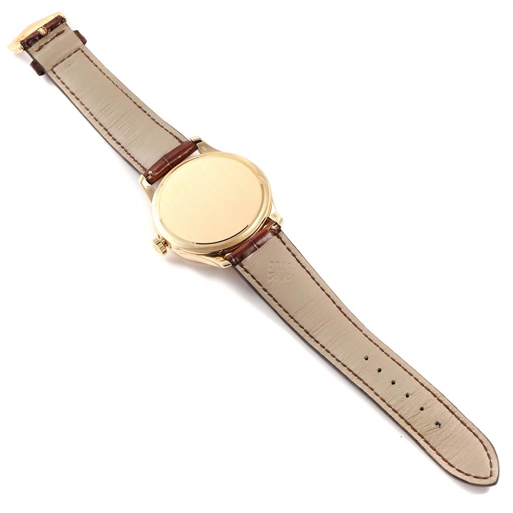 The image shows the back view of a Patek Philippe Calatrava 5227 Men's Yellow Gold Beige Dial 5227 Men's Yellow Gold Beige Dial watch, highlighting the strap and case back.