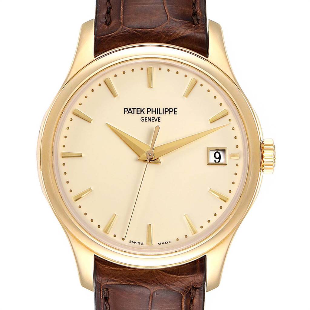 The image shows a front view of the Patek Philippe Calatrava 5227 Men's Yellow Gold Beige Dial 5227 Men's Yellow Gold Beige Dial watch, highlighting its face, dial, and brown leather strap.
