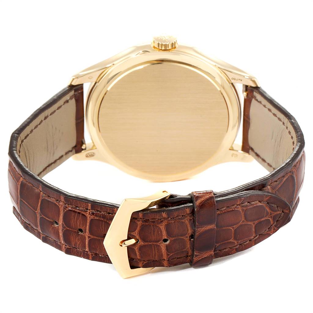The image shows the back view of a Patek Philippe Calatrava 5227 Men's Yellow Gold Beige Dial 5227 Men's Yellow Gold Beige Dial watch, highlighting its gold case and brown leather strap.