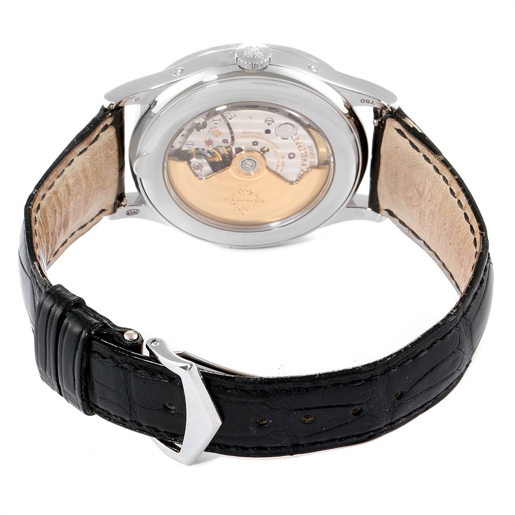 The image shows the back view of a Patek Philippe Complications 5396G-001 Men's White Gold Silver Dial 5396G-001 Men's White Gold Silver Dial model watch, displaying the movement and a black leather strap.