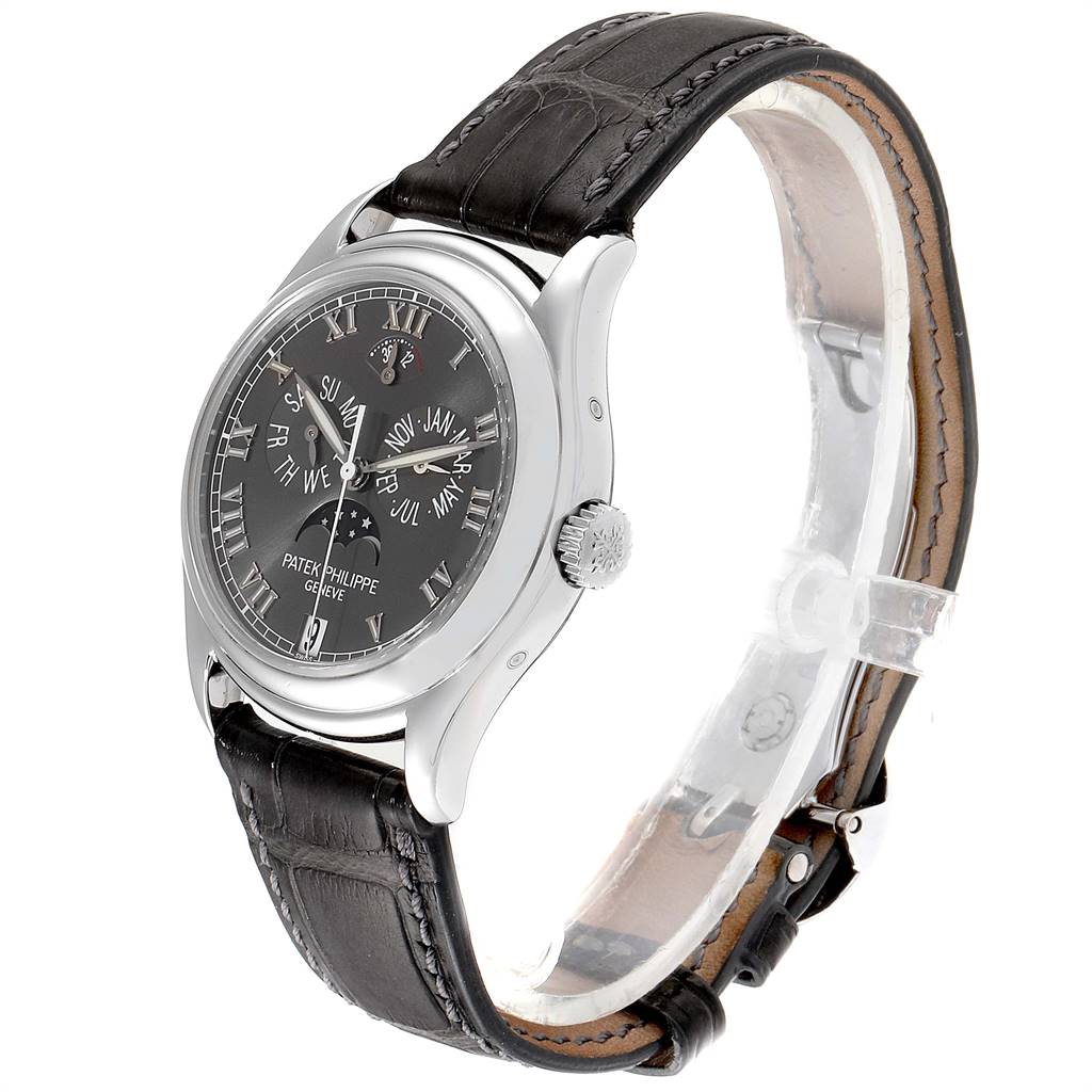 The image shows a side-angle view of the Patek Philippe Complications 5056P Men's White Gold Grey Dial 5056P Men's White Gold Grey Dial watch, highlighting the face, crown, and leather strap.