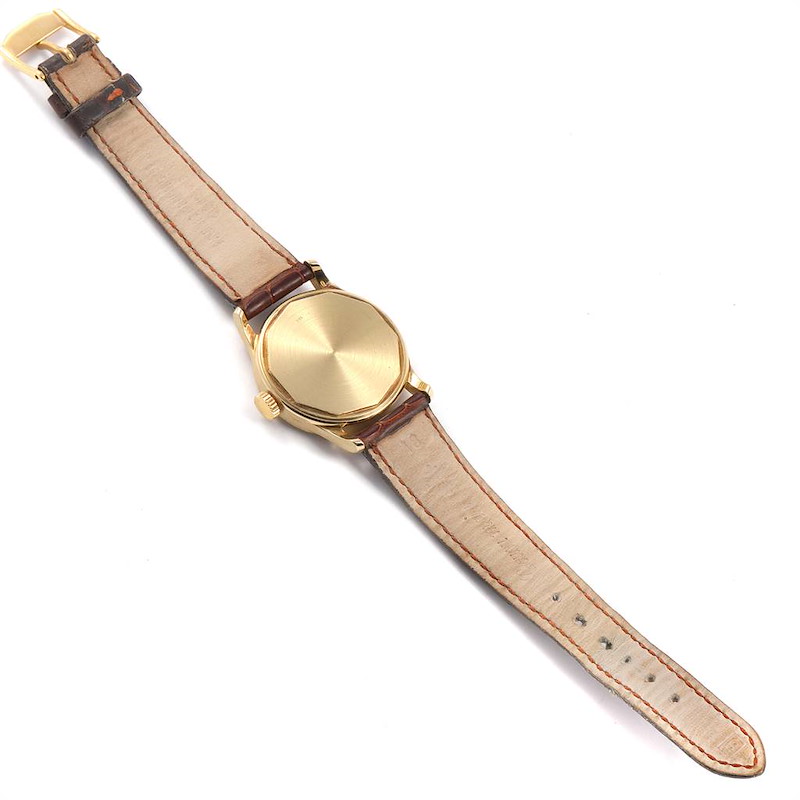 This image shows the back side of a Vintage Patek Philippe watch, highlighting the gold case and leather strap.